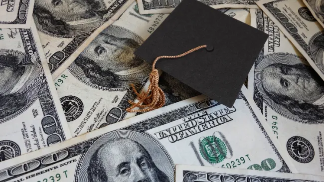 graduation cap with money